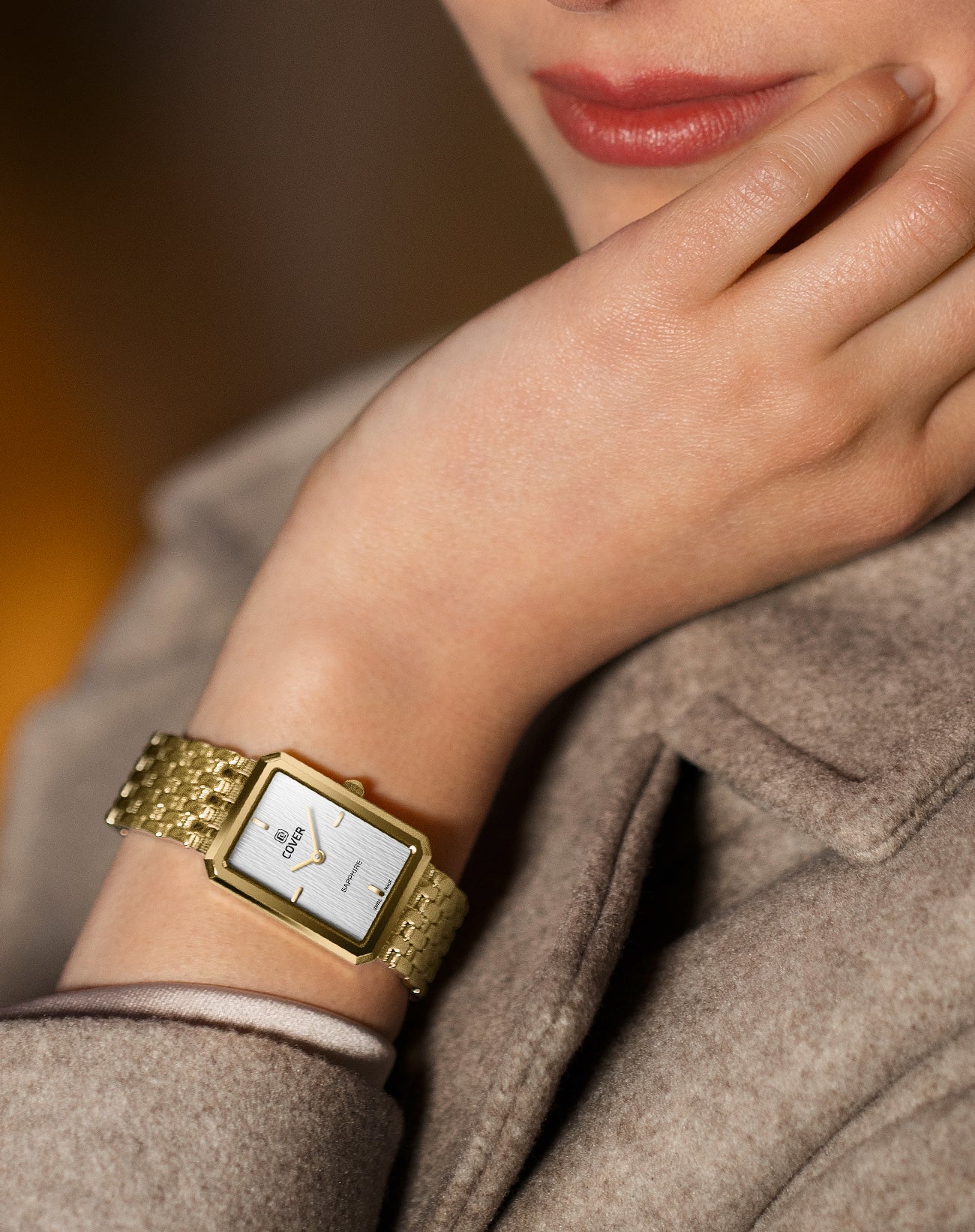 Wristshot of the COVER Noble Square women’s watch with silver dial and gold-plated bracelet worn elegantly on the wrist